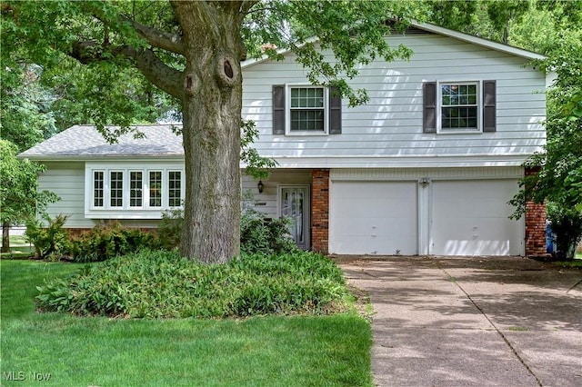 27008 Sweetbriar Dr, North Olmsted, OH 44070 - view of front of home with concrete driveway, an attached garage, and brick siding