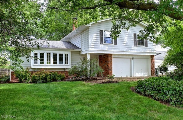 27008 Sweetbriar Dr, North Olmsted, OH 44070 - split level home with a front lawn, an attached garage, and brick siding