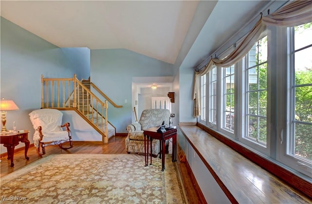 27008 Sweetbriar Dr, North Olmsted, OH 44070 - living area featuring vaulted ceiling, wood finished floors, and stairs