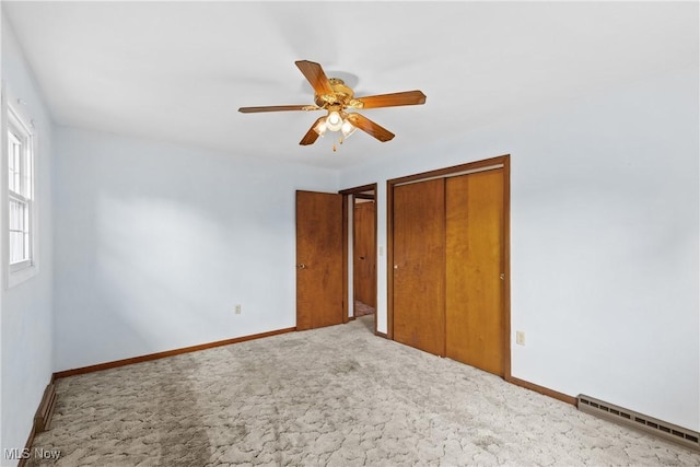 59937 Broadview Rd, Shadyside, OH 43947 - unfurnished bedroom featuring a baseboard heating unit, carpet floors, a closet, and ceiling fan