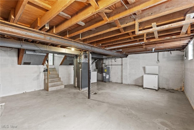 59937 Broadview Rd, Shadyside, OH 43947 - unfinished basement featuring electric water heater, stairway, and heating unit