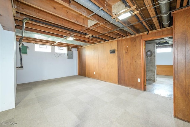 810 Indian Trl, Akron, OH 44314 - basement with light flooring, electric panel, and wooden walls