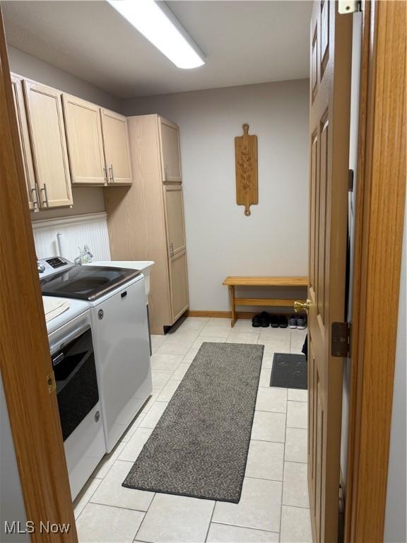 7536 Monterey Bay Dr Unit 2, Mentor-On-The-Lake, OH 44060 - laundry room with washer and dryer, cabinet space, and light tile patterned floors