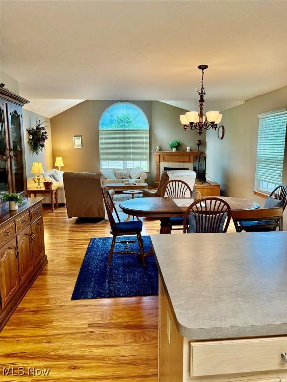 7536 Monterey Bay Dr Unit 2, Mentor-On-The-Lake, OH 44060 - dining room featuring light wood-type flooring, a chandelier, and lofted ceiling