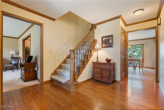 6884 Mapleridge Cir NW, Canton, OH 44718 - stairway with crown molding and hardwood / wood-style floors