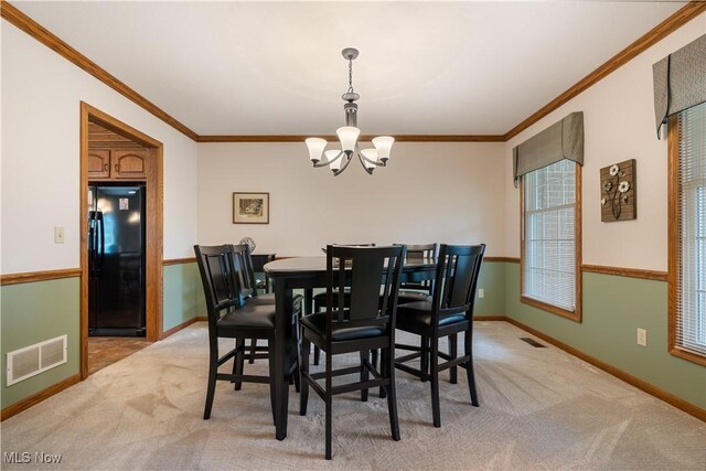 6884 Mapleridge Cir NW, Canton, OH 44718 - dining space with a chandelier, ornamental molding, and light colored carpet