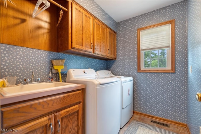 6884 Mapleridge Cir NW, Canton, OH 44718 - washroom with cabinet space, independent washer and dryer, and wallpapered walls