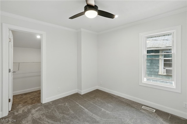 848 Kling St, Akron, OH 44311 - unfurnished bedroom featuring dark colored carpet, a spacious closet, ornamental molding, a closet, and a ceiling fan