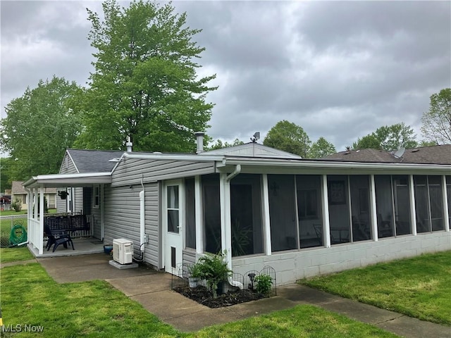 723 High Ave, Niles, OH 44446 - rear view of house with a sunroom, a yard, a patio area, and a shingled roof