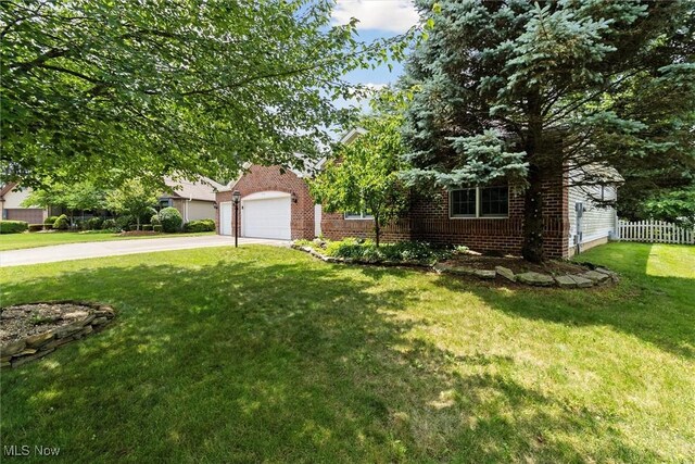 1012 Woodland Chase, Grafton, OH 44044 - view of property hidden behind natural elements featuring concrete driveway and brick siding