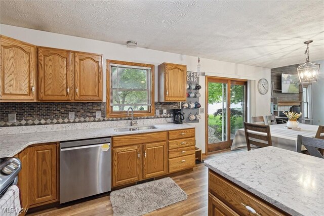 1012 Woodland Chase, Grafton, OH 44044 - kitchen with stainless steel dishwasher, range, light wood finished floors, plenty of natural light, and a textured ceiling