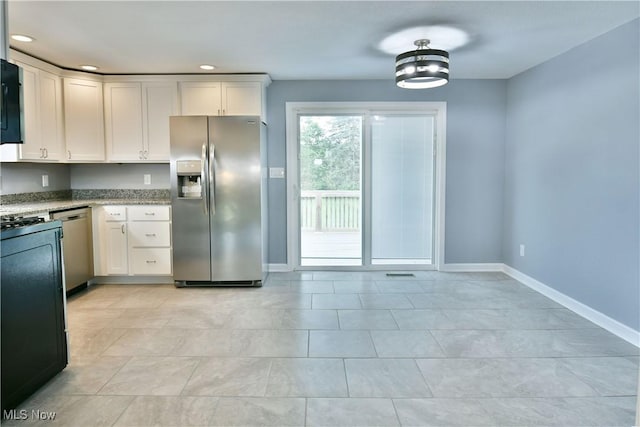 22 Camrose Dr, Niles, OH 44446 - kitchen featuring stainless steel appliances, white cabinetry, light stone countertops, recessed lighting, and light tile patterned floors