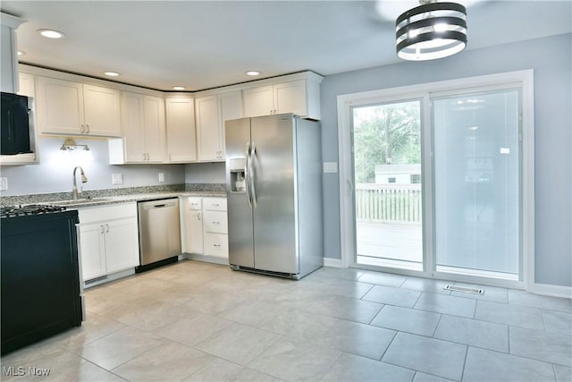 22 Camrose Dr, Niles, OH 44446 - kitchen featuring stainless steel appliances, light stone counters, white cabinetry, recessed lighting, and light tile patterned floors