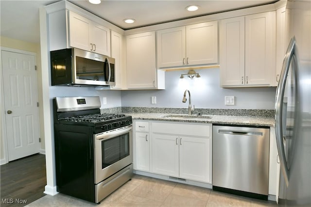 22 Camrose Dr, Niles, OH 44446 - kitchen with appliances with stainless steel finishes, recessed lighting, light stone counters, and white cabinets