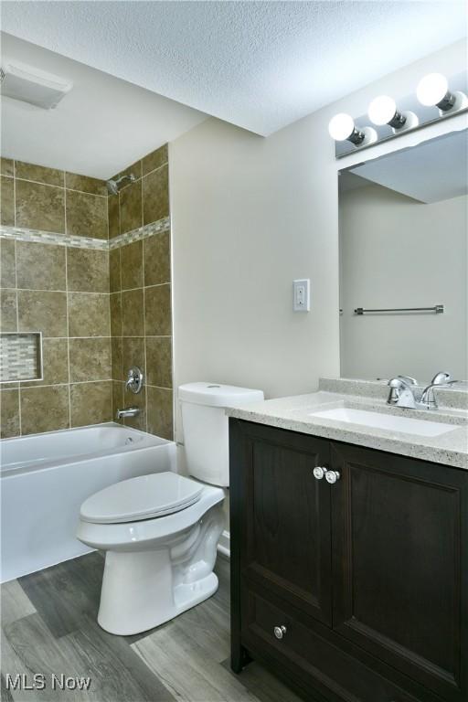 22 Camrose Dr, Niles, OH 44446 - full bath featuring vanity, wood finished floors, a textured ceiling, and tub / shower combination