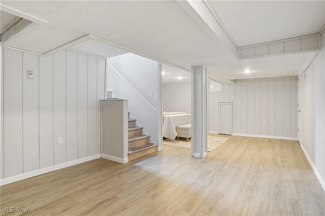 3382 Ormond Rd, Cleveland Heights, OH 44118 - finished basement with wood finished floors, stairway, and a decorative wall