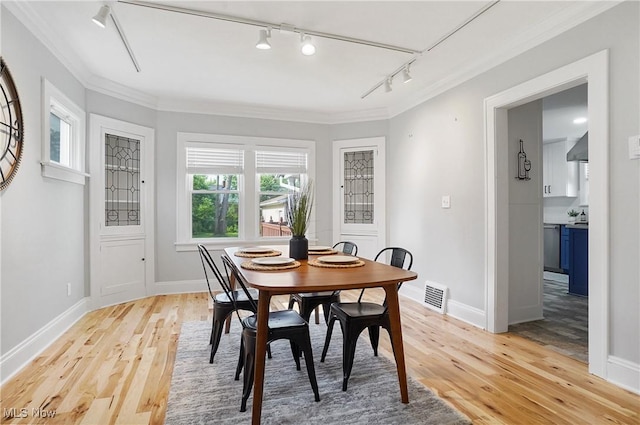 3382 Ormond Rd, Cleveland Heights, OH 44118 - dining room featuring track lighting, light wood-type flooring, and crown molding