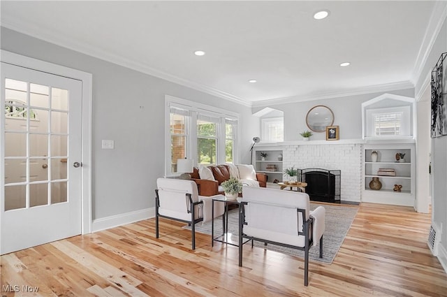 3382 Ormond Rd, Cleveland Heights, OH 44118 - living room featuring crown molding, light wood-type flooring, a brick fireplace, and recessed lighting