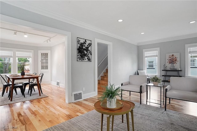 3382 Ormond Rd, Cleveland Heights, OH 44118 - living room with stairs, light wood finished floors, healthy amount of natural light, ornamental molding, and recessed lighting