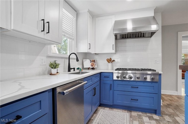 3382 Ormond Rd, Cleveland Heights, OH 44118 - kitchen featuring appliances with stainless steel finishes, wall chimney range hood, blue cabinetry, and white cabinets