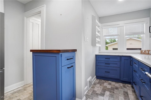 3382 Ormond Rd, Cleveland Heights, OH 44118 - kitchen with blue cabinetry and baseboards