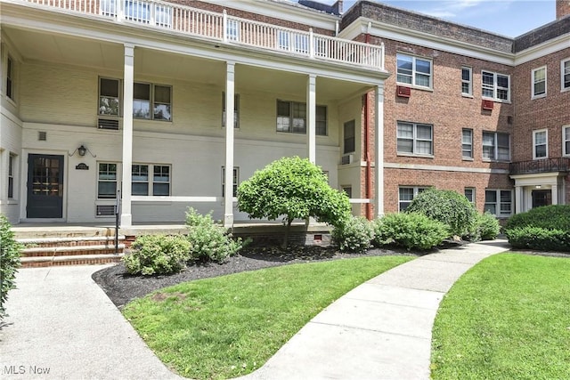15875 Van Aken Blvd Unit 101C, Shaker Heights, OH 44120 - doorway to property with a yard, a balcony, and brick siding