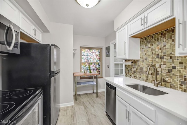 15875 Van Aken Blvd Unit 101C, Shaker Heights, OH 44120 - kitchen featuring stainless steel appliances, light countertops, white cabinetry, and tasteful backsplash