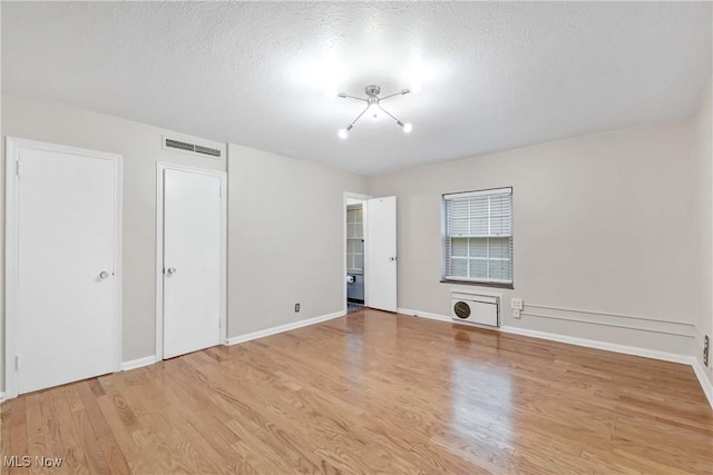 15875 Van Aken Blvd Unit 101C, Shaker Heights, OH 44120 - unfurnished bedroom with light wood-type flooring and a textured ceiling