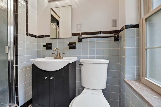 15875 Van Aken Blvd Unit 101C, Shaker Heights, OH 44120 - bathroom featuring tile walls, vanity, an enclosed shower, and healthy amount of natural light