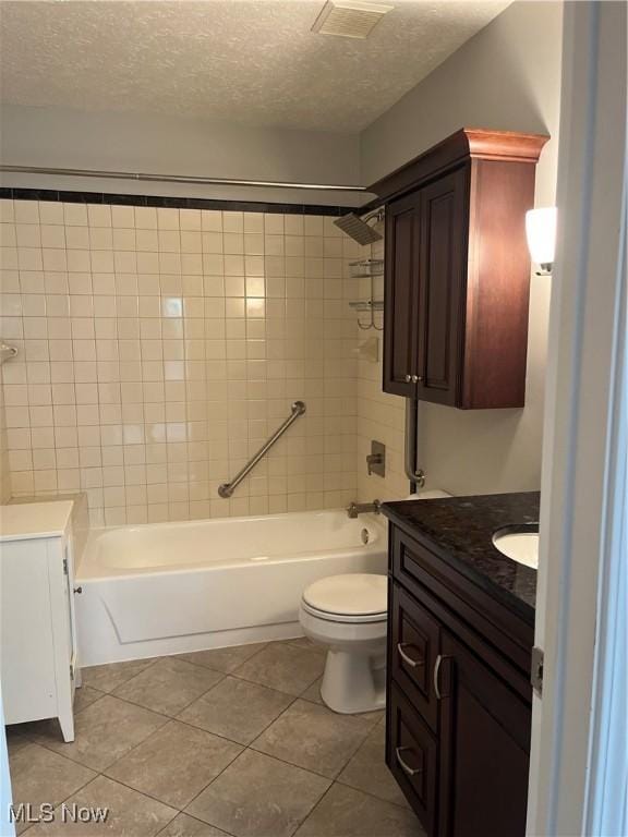 1235 Canyon View Rd, Sagamore Hills, OH 44067 - bathroom featuring tile patterned floors, a textured ceiling, vanity, and washtub / shower combination