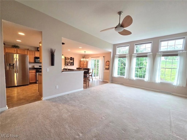 125 Fitch Blvd Unit 263, Austintown, OH 44515 - unfurnished living room with light colored carpet, a chandelier, ceiling fan, and recessed lighting