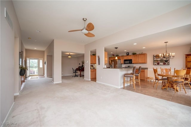 125 Fitch Blvd Unit 263, Austintown, OH 44515 - living room with light colored carpet, ceiling fan, recessed lighting, and a chandelier
