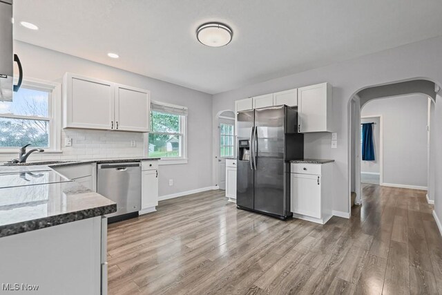 2515 Saratoga Ave SW, Canton, OH 44706 - kitchen featuring stainless steel appliances, arched walkways, white cabinets, light wood-style flooring, and recessed lighting