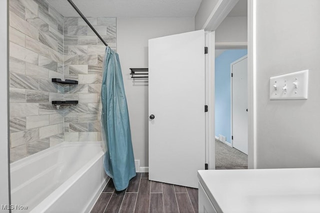 2515 Saratoga Ave SW, Canton, OH 44706 - bathroom featuring shower / bath combo with shower curtain, wood finish floors, and vanity