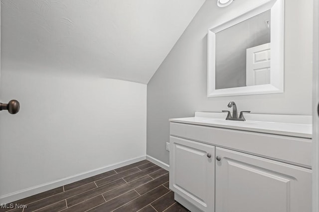 2515 Saratoga Ave SW, Canton, OH 44706 - bathroom featuring lofted ceiling, vanity, and wood finished floors