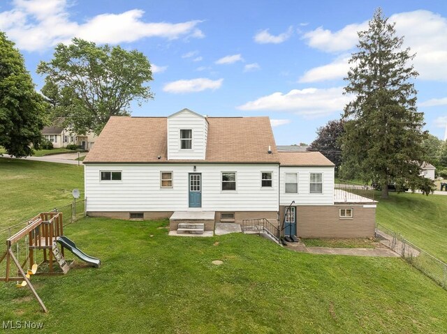 2515 Saratoga Ave SW, Canton, OH 44706 - rear view of house with a fenced backyard and a playground