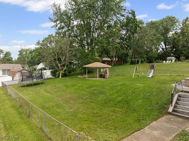 2515 Saratoga Ave SW, Canton, OH 44706 - view of yard featuring a playground, a trampoline, a gazebo, and view of wooded area