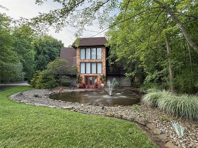 265 Schneiders Crossing Rd NW, Dover, OH 44622 - rear view of house with a lawn and brick siding
