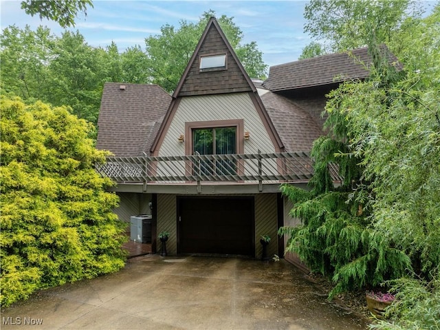 265 Schneiders Crossing Rd NW, Dover, OH 44622 - view of front facade with a shingled roof, concrete driveway, and a garage