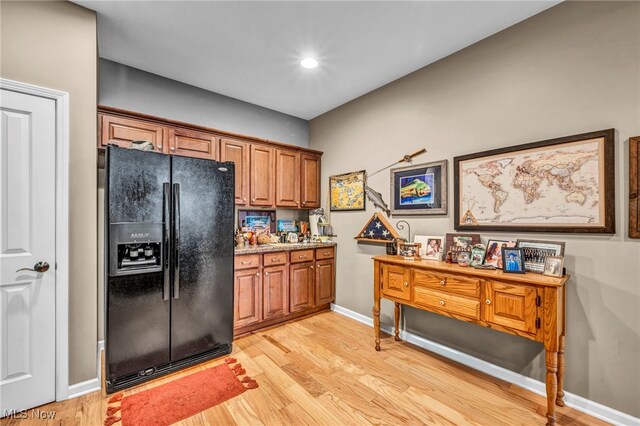 3845 Windsor Bridge Cir, Huron, OH 44839 - kitchen featuring black refrigerator with ice dispenser, light wood finished floors, brown cabinetry, and recessed lighting