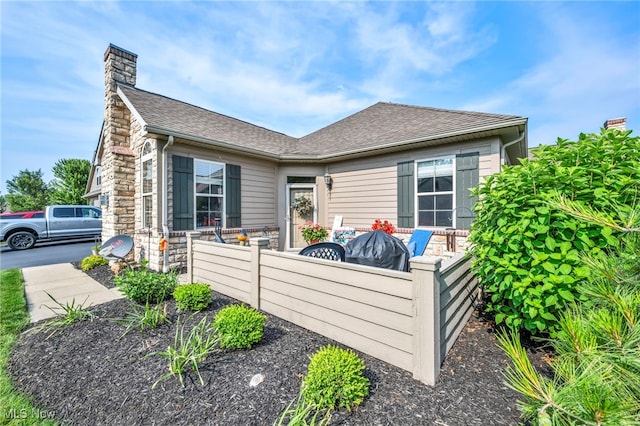 3845 Windsor Bridge Cir, Huron, OH 44839 - view of home's exterior featuring a chimney and a shingled roof
