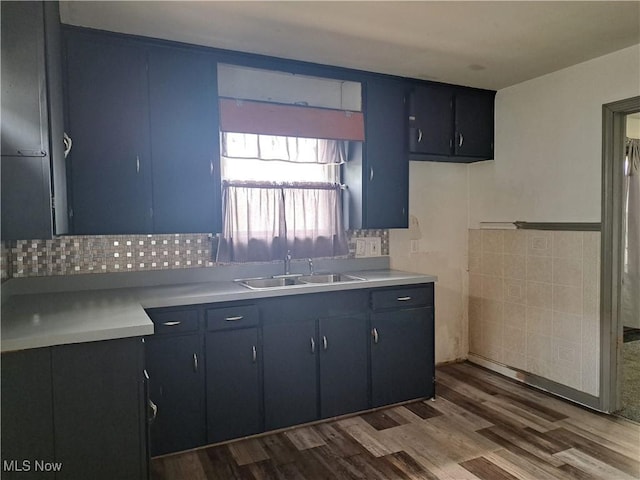 2239 N Ridge Rd E, Lorain, OH 44055 - kitchen featuring light countertops, dark wood-type flooring, and decorative backsplash