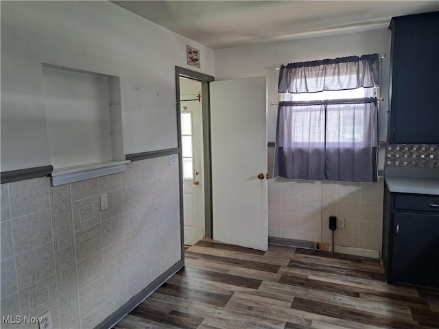 2239 N Ridge Rd E, Lorain, OH 44055 - bathroom featuring tile walls, wood finished floors, and wainscoting