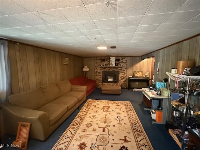 213 Highland Park, Bloomingdale, OH 43910 - carpeted living room featuring wooden walls, a fireplace, and a drop ceiling