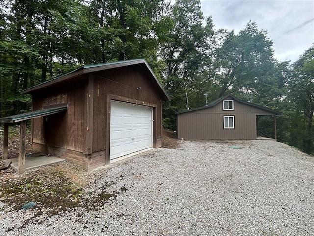 61342 High Hill Rd, Cambridge, OH 43725 - detached garage with gravel driveway and view of wooded area