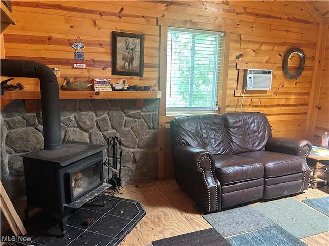 61342 High Hill Rd, Cambridge, OH 43725 - living area with wooden walls, wood finished floors, an AC wall unit, and a wood stove