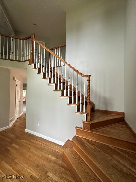 5330 Willow Ln, Sheffield Lake, OH 44054 - staircase with wood finished floors and a towering ceiling