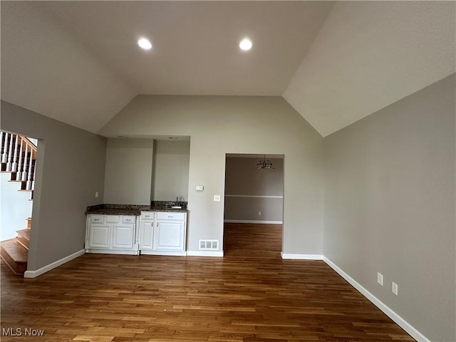 5330 Willow Ln, Sheffield Lake, OH 44054 - bar featuring stairs, vaulted ceiling, dark wood finished floors, and recessed lighting