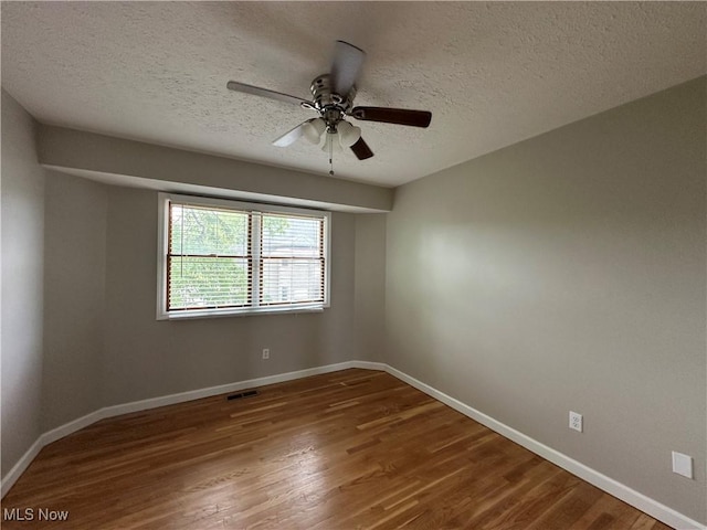 5330 Willow Ln, Sheffield Lake, OH 44054 - spare room featuring wood finished floors, a ceiling fan, and a textured ceiling