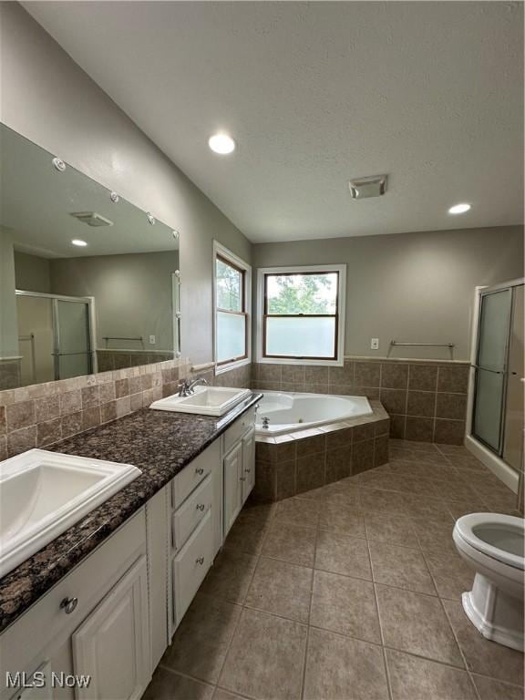 5330 Willow Ln, Sheffield Lake, OH 44054 - bathroom with a bath, double vanity, a shower stall, tile patterned flooring, and recessed lighting